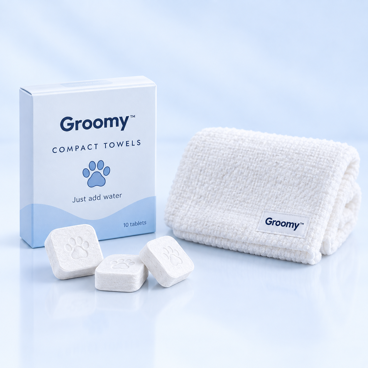 Groomy Compact Towels box with compressed towel tablets and an expanded towel.